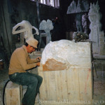 man hand carving from solid marble rock a sculptured tomb