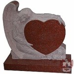 marble angel holding brown granite heart grave stone