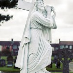 full statue Jesus carrying a cross memorial